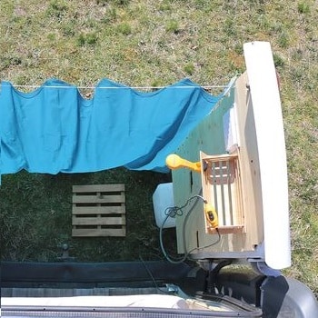 outdoor solar shower behind the van